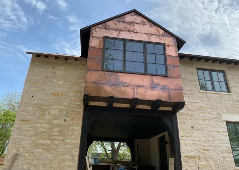 Copper metal panel facade on a stone building for Skylight Installation in Trumann